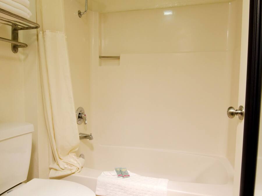 A bathroom with a toilet, a shower, and a bathtub.