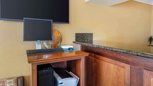 A hotel room with a desk, two monitors, a keyboard, a mouse, a printer, and a granite countertop. - Best Western Hanford Inn (Hanford)