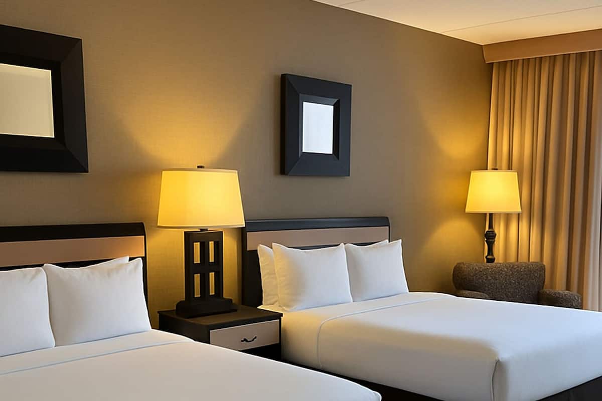 Ropa de cama de alta calidad y caja de seguridad en la habitación