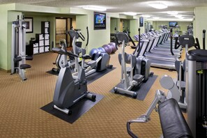 A gym with multiple treadmills, elliptical machines, and free weights. - DoubleTree by Hilton Denver Tech Center (Greenwood Village)