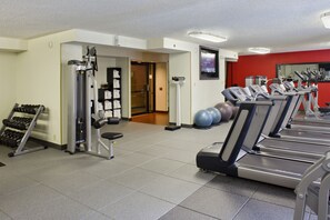 A gym with treadmills, exercise balls, and weight machines. - DoubleTree by Hilton Denver Tech Center (Greenwood Village)
