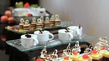 A dessert buffet with various cakes and pastries.