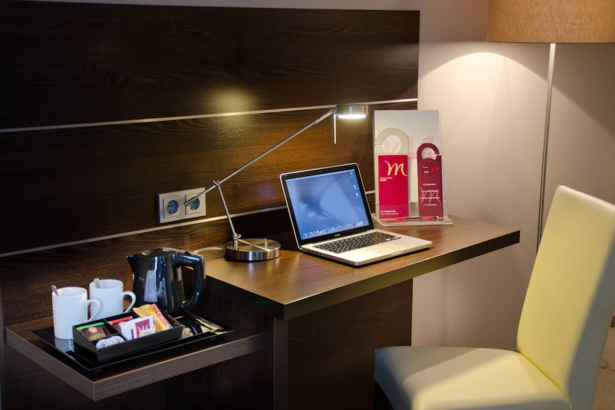 Hypo-allergenic bedding, down duvets, desk, laptop workspace