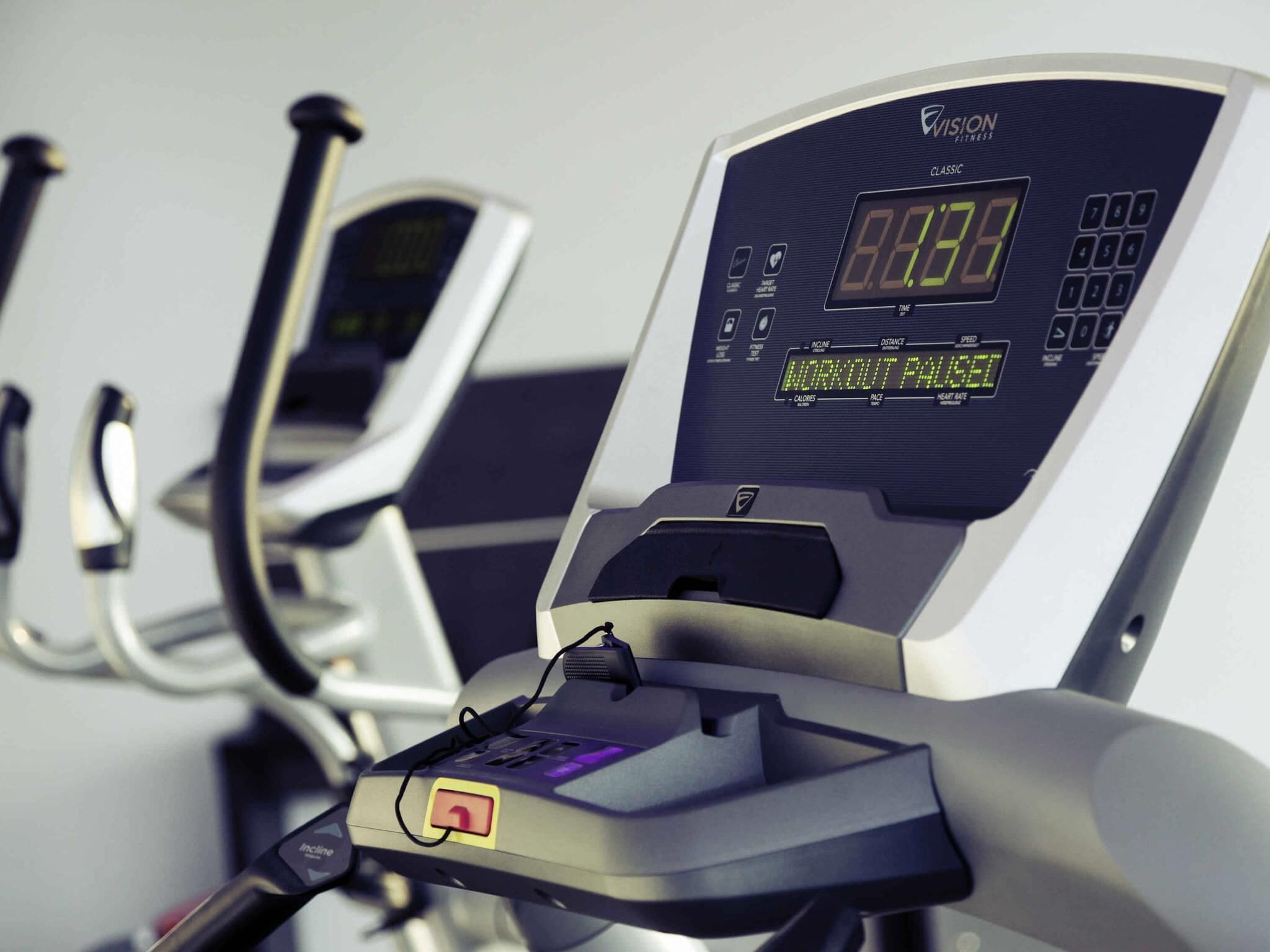 A stationary exercise bike with a digital display and control panel.