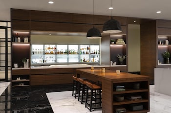 A spacious lobby with large windows, a patterned floor, and a modern ceiling design. at Hyatt Regency Orlando