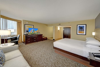 A fast-food restaurant with a burger bar and a display case filled with snacks. at Hilton Orlando/Altamonte Springs