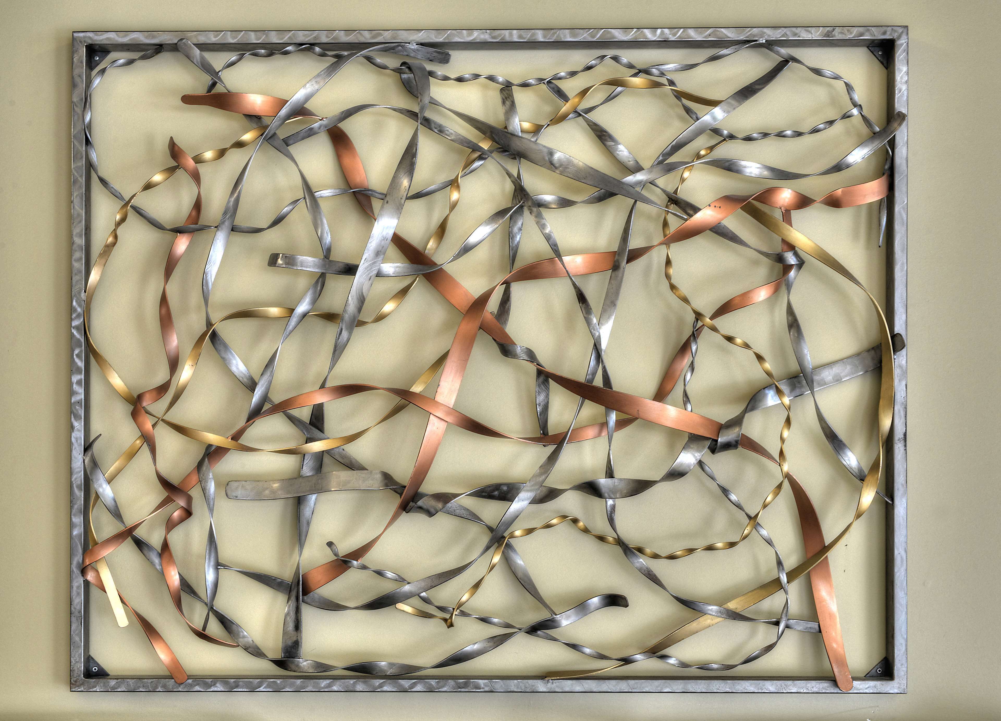 Obra de arte abstracta enmarco con cintas metálicas.