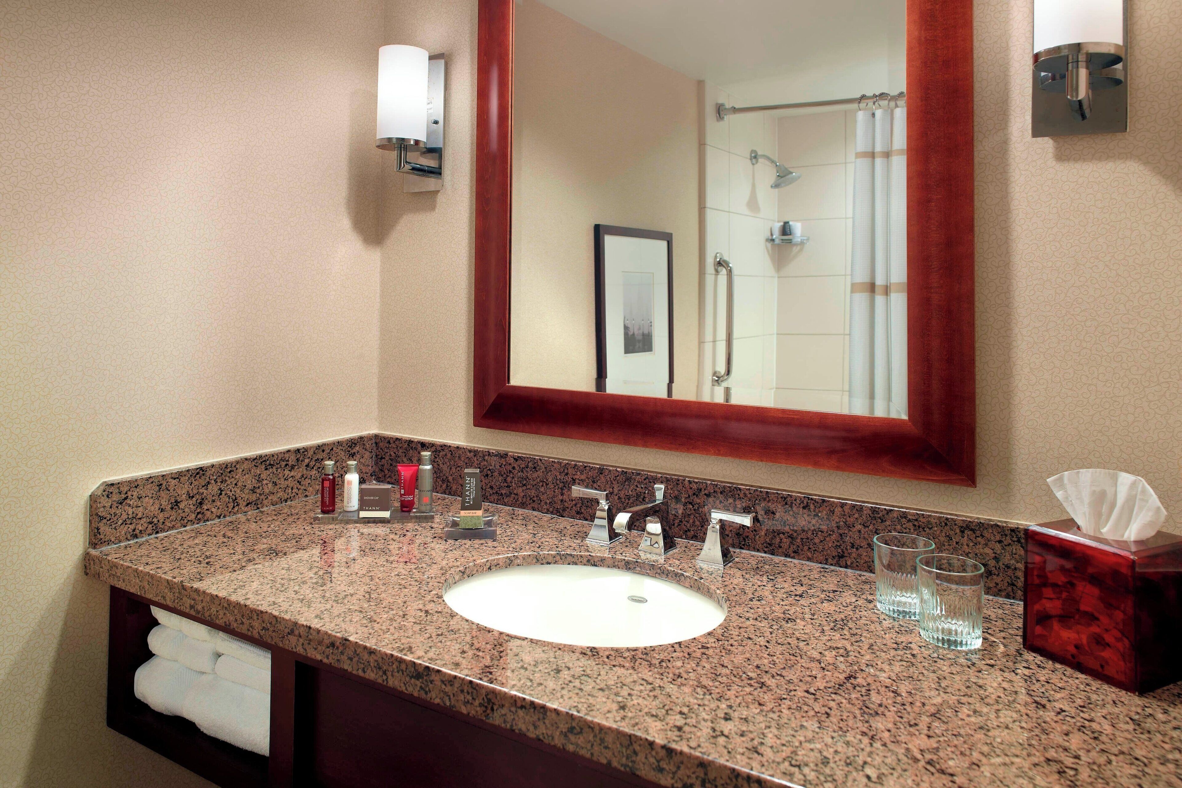 combined shower/bathtub, designer toiletries, hair dryer, towels