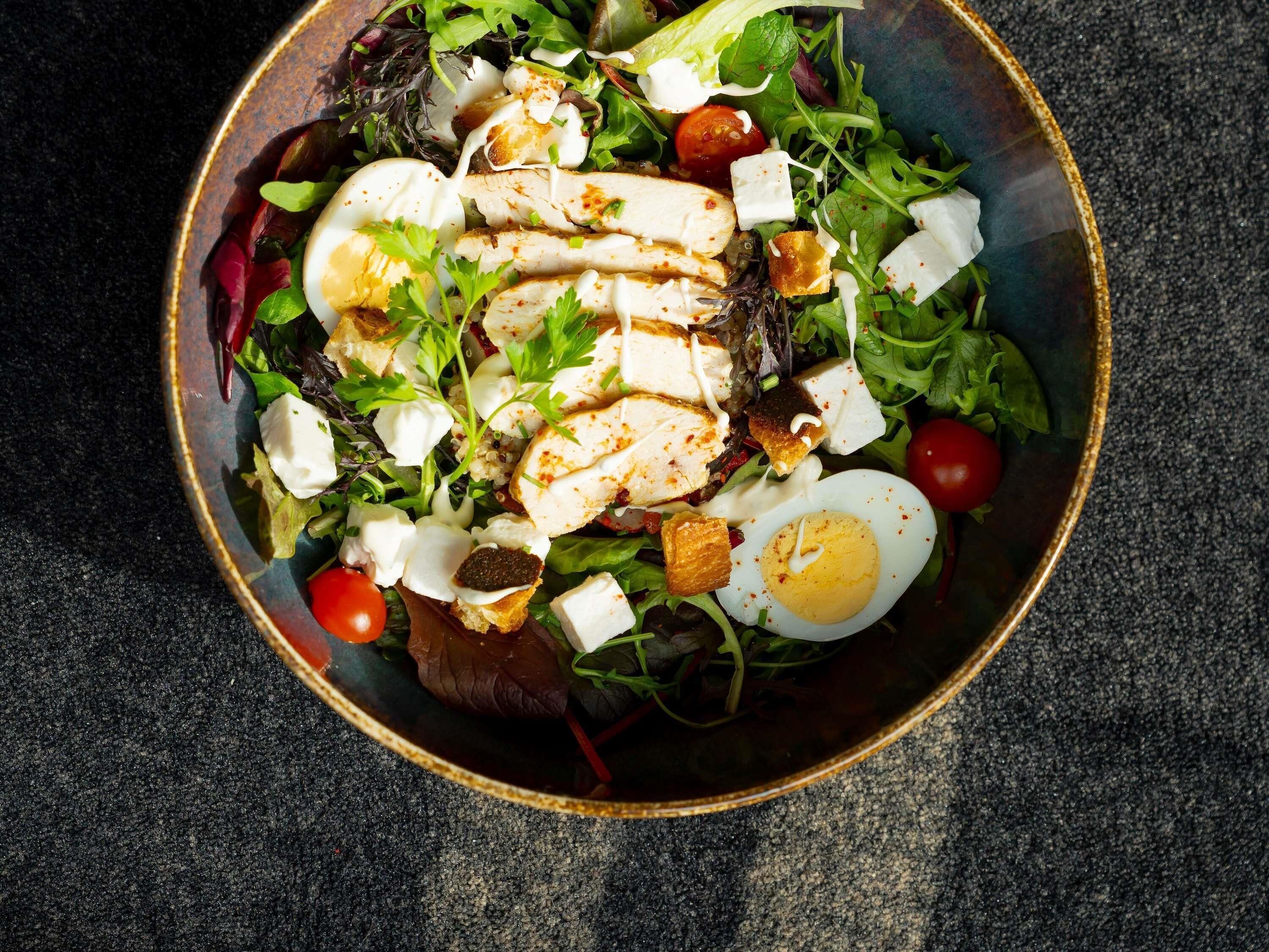 A bowl of salad with various ingredients.
