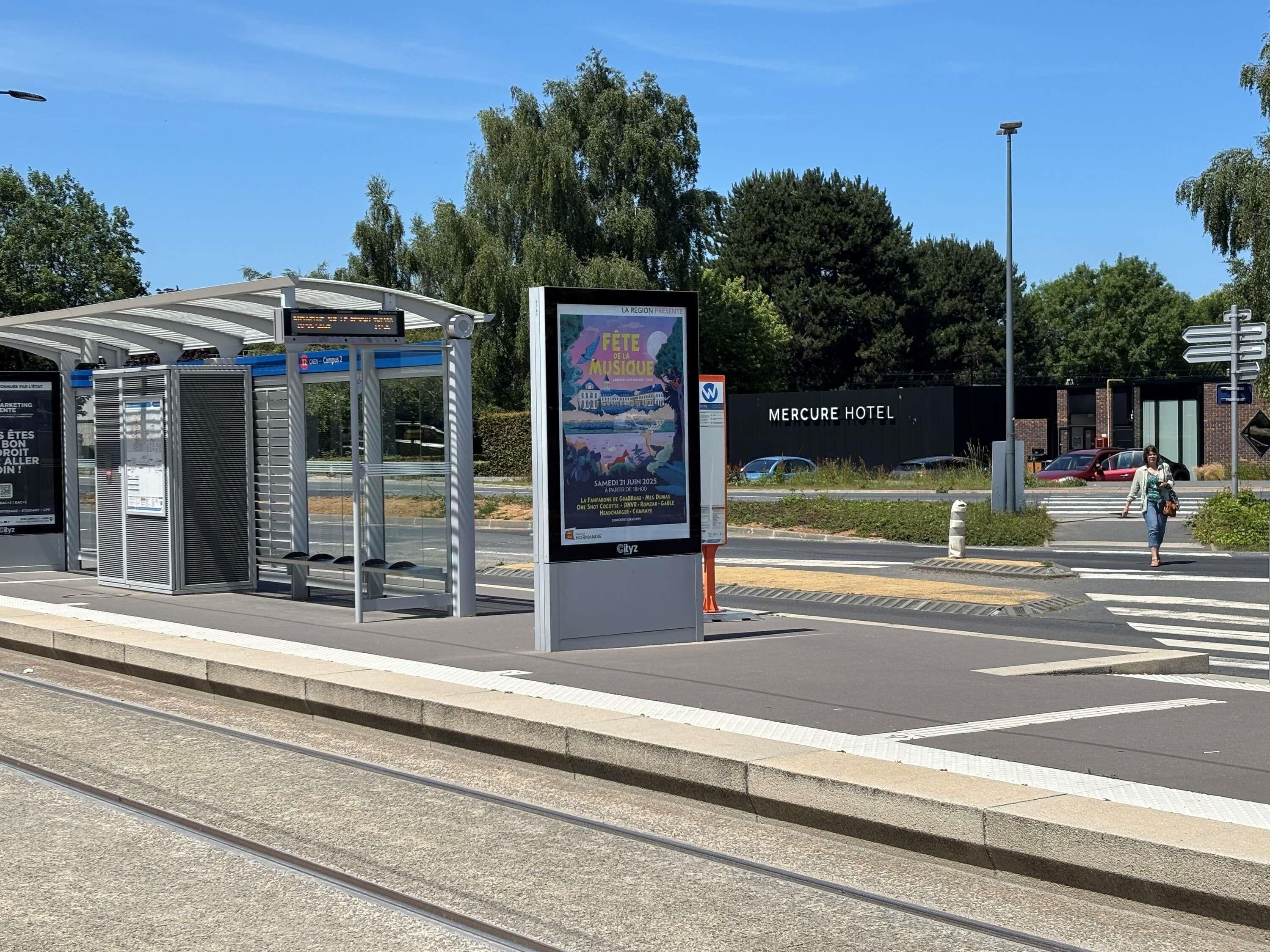 A bus stop with a shelter, a Mercure Hotel sign, and a pedestrian crossing.