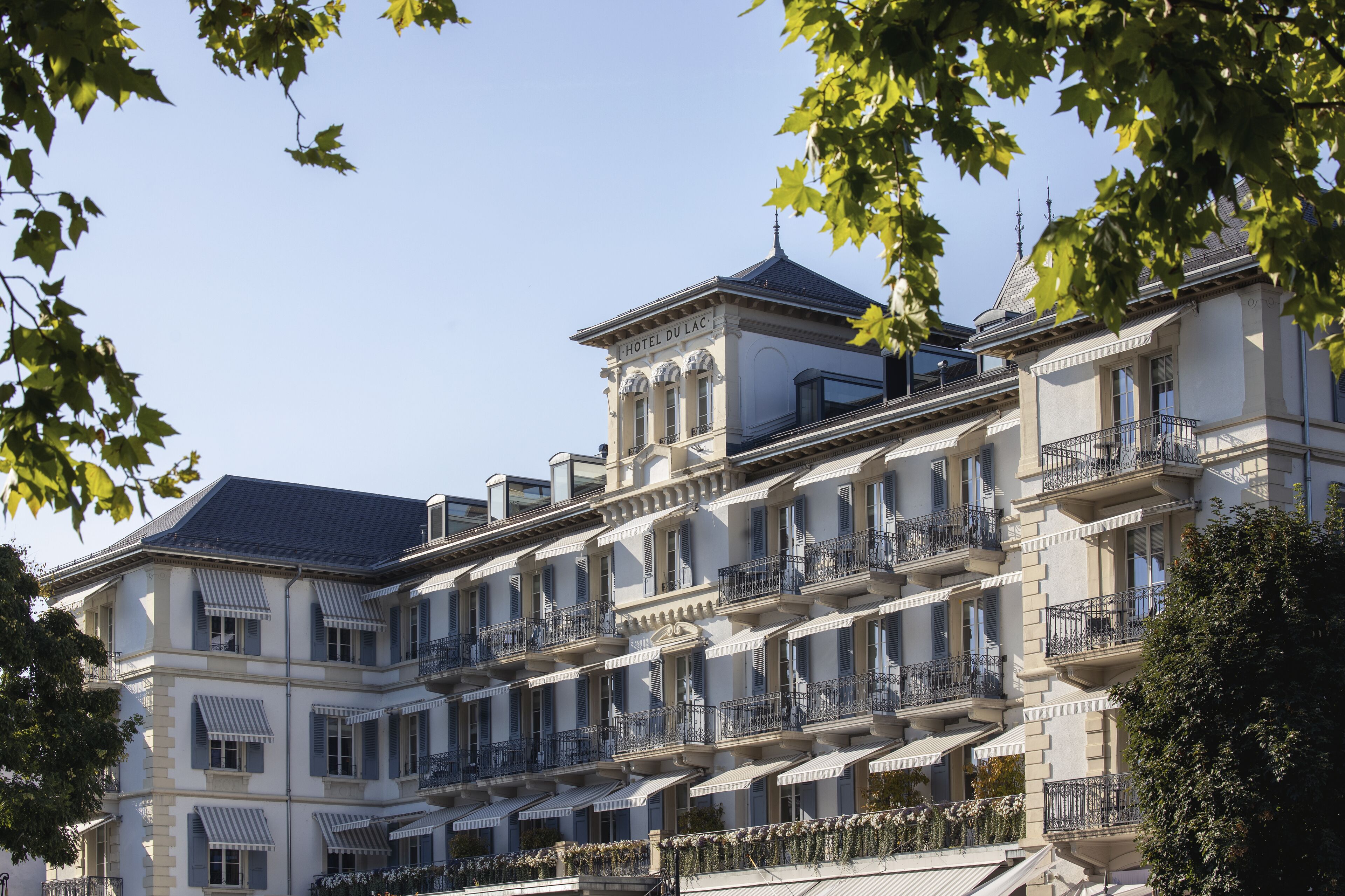 A multi-story hotel with balconies and a classic architectural style.