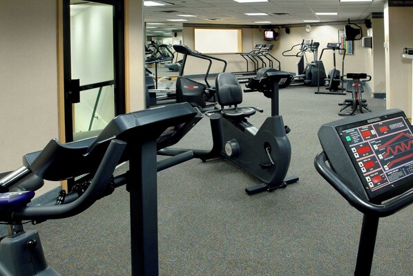 A gym with stationary bikes, treadmills, and an elliptical machine. - Long Island Marriott (Uniondale)