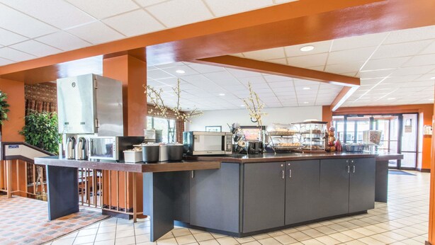 A spacious kitchen with a large island, equipped with various appliances and a buffet setup.