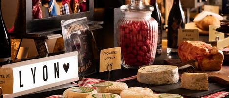 A cheese display with labels, a jar of raspberries, and a sign reading 'LYON'.
