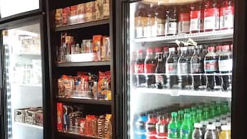 A refrigerated display case with various beverages and snacks.