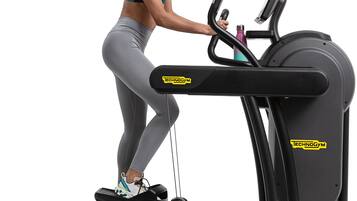 A person using a treadmill with a visible brand logo, a control panel, and a foot pedal.