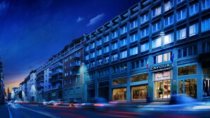 A multi-story hotel with a modern facade, featuring balconies and large windows. - Hotel Cavour (Milan)