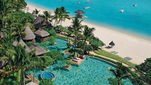 A resort with a swimming pool, beach, and ocean view. - La Pirogue Mauritius (Flic-en-Flac)