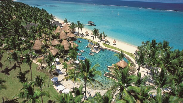 A resort with a pool, beach, and palm trees. - La Pirogue Mauritius (Flic-en-Flac)