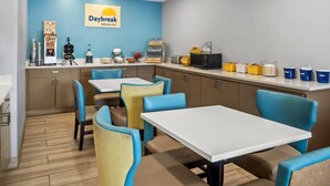 A Daybreak breakfast area with tables and chairs, kitchen appliances, and storage containers. - Days Inn by Wyndham Renfro Valley Mount Vernon (Mount Vernon)
