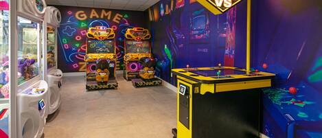 A gaming arcade with various machines and a foosball table.