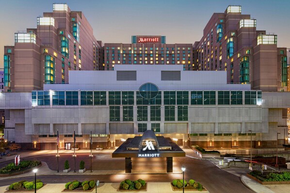 A Marriott hotel with a prominent entrance, large windows, and a well-lit facade.
