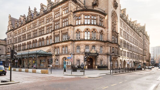 A historic building with a grand entrance, multiple windows, and a prominent corner tower. - voco Grand Central Glasgow by IHG (Glasgow)