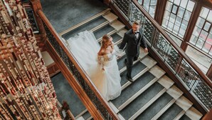 A grand staircase with a bride and groom ascending. - voco Grand Central Glasgow by IHG (Glasgow)