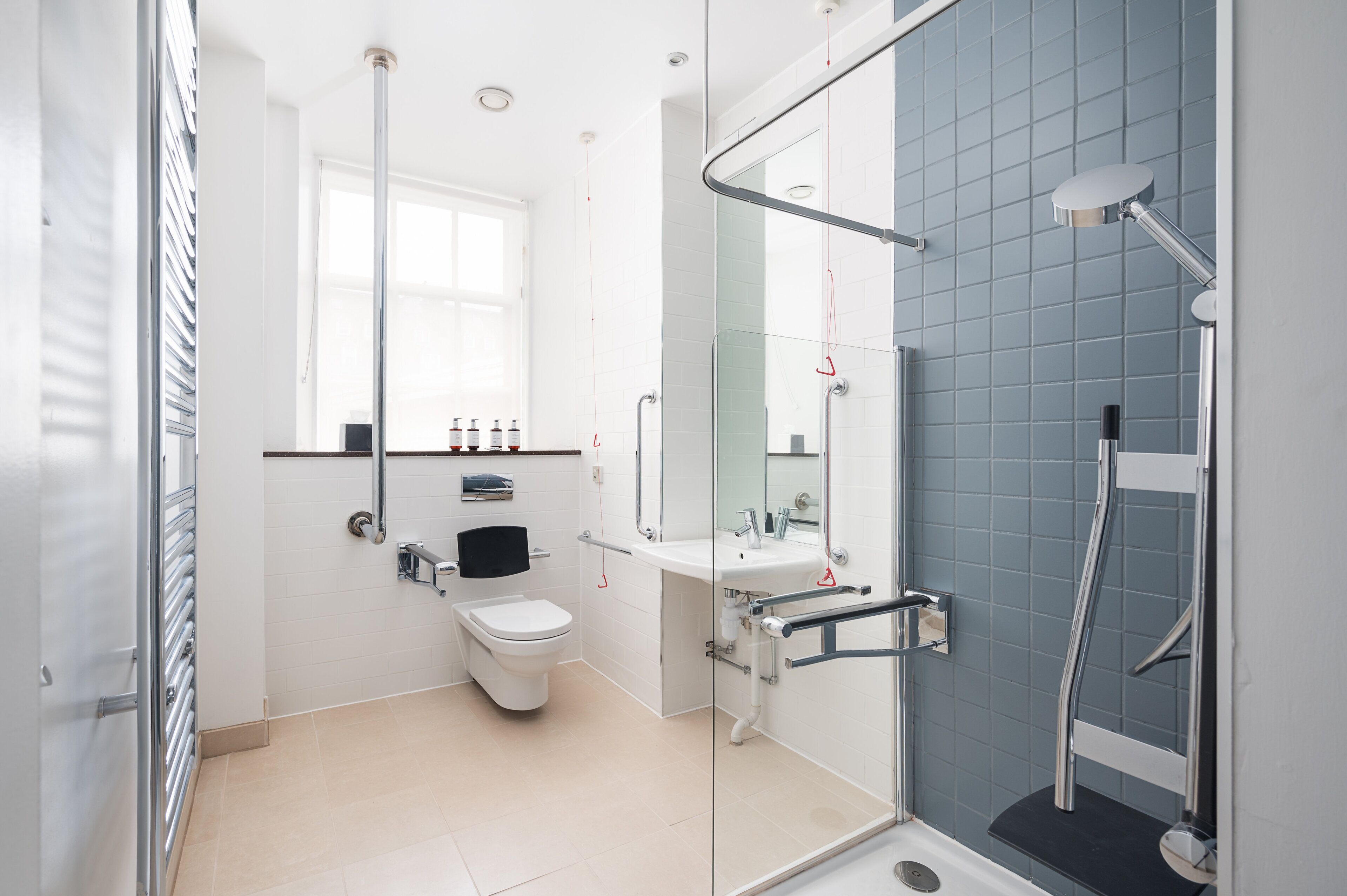A modern bathroom with a toilet, sink, and shower area.