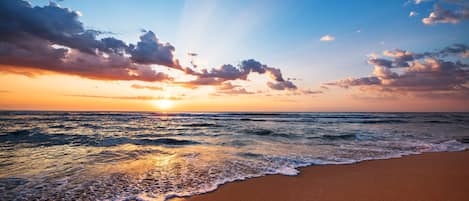 On the beach, white sand, beach cabanas, sun loungers