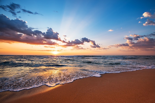 On the beach, white sand, beach cabanas, sun loungers