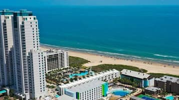 On the beach, white sand, beach cabanas, sun loungers