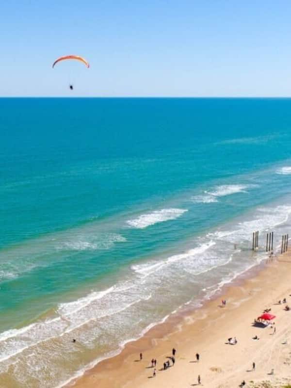 On the beach, white sand, beach cabanas, sun loungers