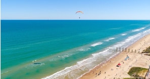 On the beach, white sand, beach cabanas, sun-loungers
