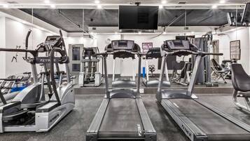 A gym with treadmills, ellipticals, and weight machines.
