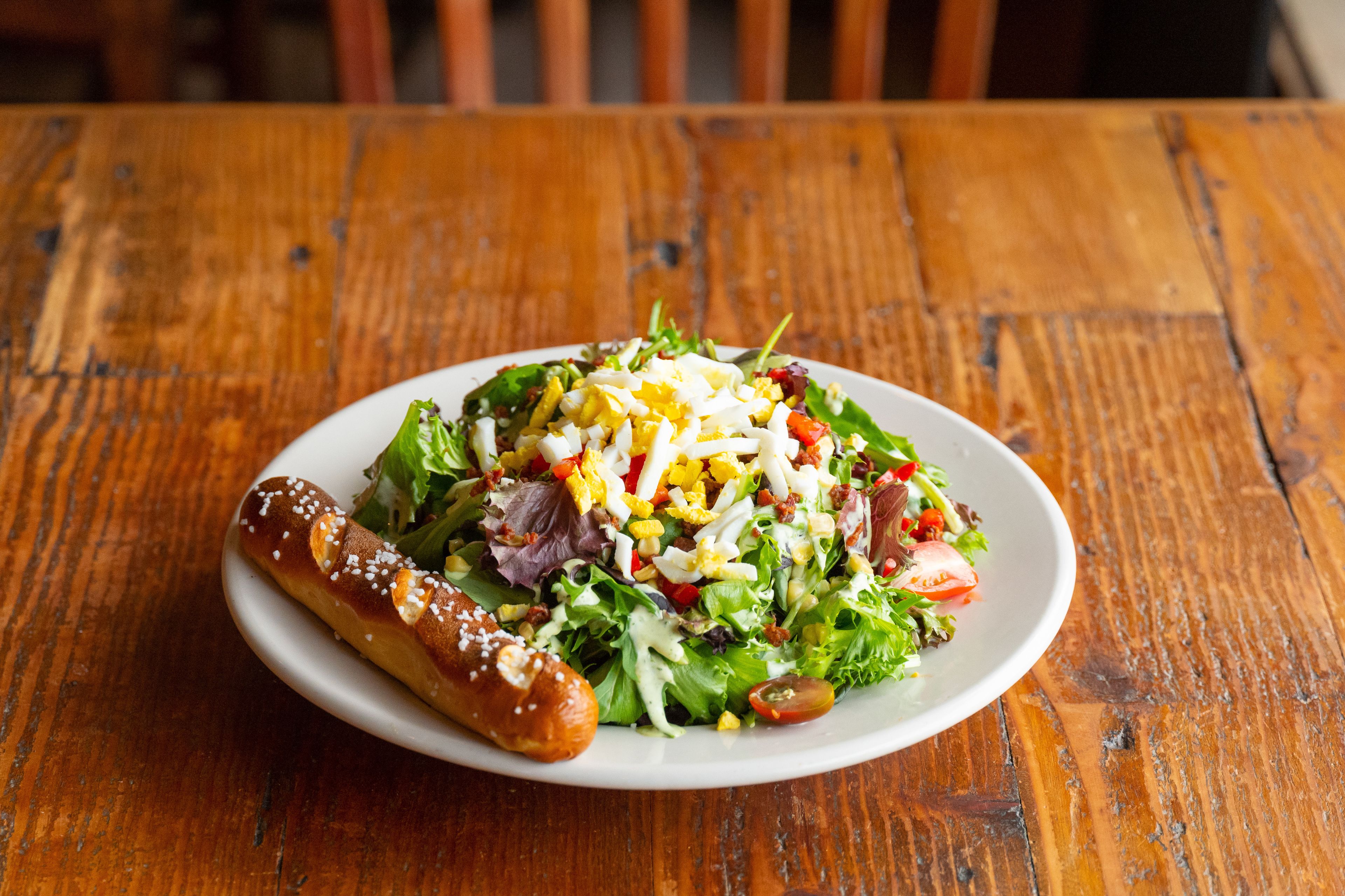 A plate of food on a wooden table.
