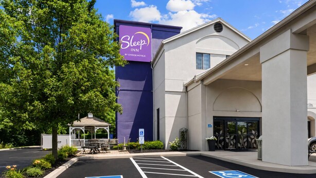 A Sleep Inn hotel with a parking lot, handicap accessible parking spaces, and a gazebo.