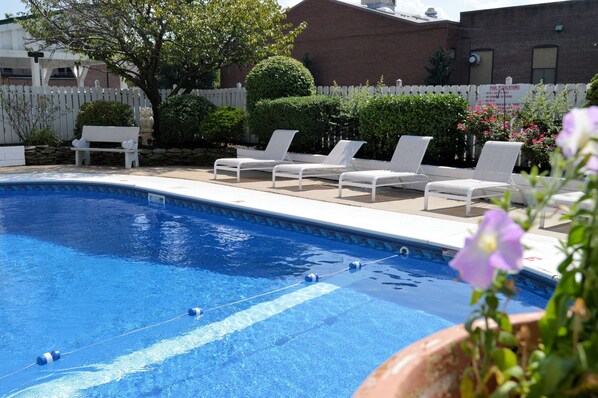 Outdoor pool, open 10:00 AM to 10:00 PM, pool umbrellas