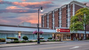 A hotel with a modern brick facade, a prominent 'Best Western PLUS' sign, and a well-maintained front garden with trimmed bushes and a street lamp. - Best Western Plus Genetti Wilkes Barre (Wilkes-Barre)