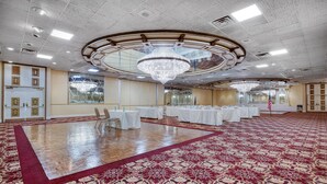 A spacious ballroom with a large chandelier, white tables, and a red carpet. - Best Western Plus Genetti Wilkes Barre (Wilkes-Barre)