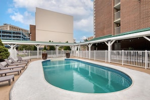 Outdoor pool, open 10:00 AM to 10:00 PM, pool umbrellas