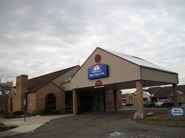 Americas Best Value Inn features a classic pitched roof and brick exterior, with a covered entrance and ample parking.
