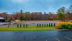 A parking lot with trees in the background. - Red Roof Inn & Suites Hazleton (Hazleton)