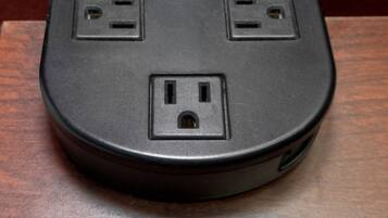 A black power strip with two standard electrical outlets and one USB port.