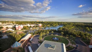 A hotel with a central courtyard, a river view, and a fountain. - Walt Disney World Swan (Lake Buena Vista)