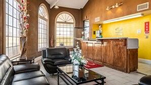 A lobby with leather sofas, a reception desk, and large windows. - Econo Lodge Acworth East (Acworth)