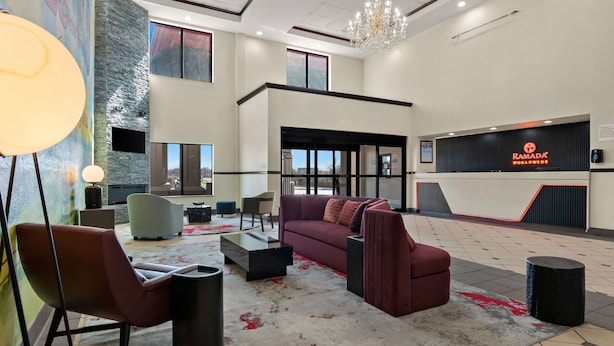 Eine moderne Lobby mit Empfangstresen, Sitzgelegenheiten und einem Chandelier.