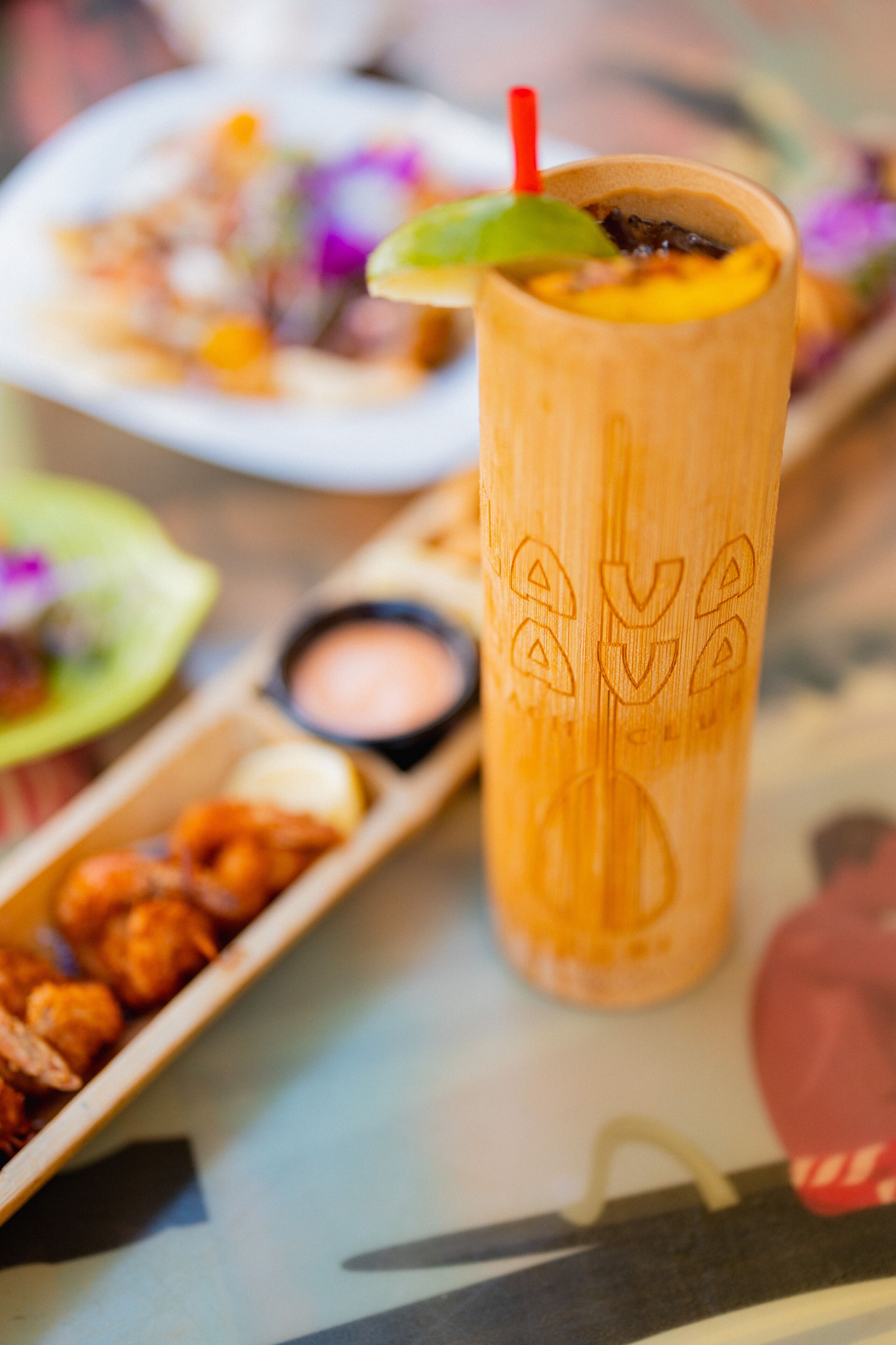 A wooden table with a drink and food items.