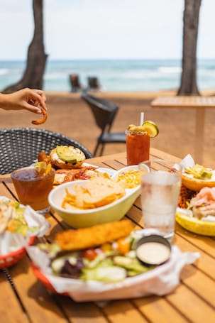 Breakfast, lunch, dinner served; local cuisine, beach views . Kauai Shores Hotel