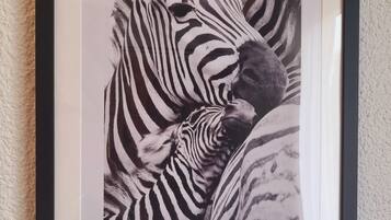 A framed black and white photograph of a zebra.